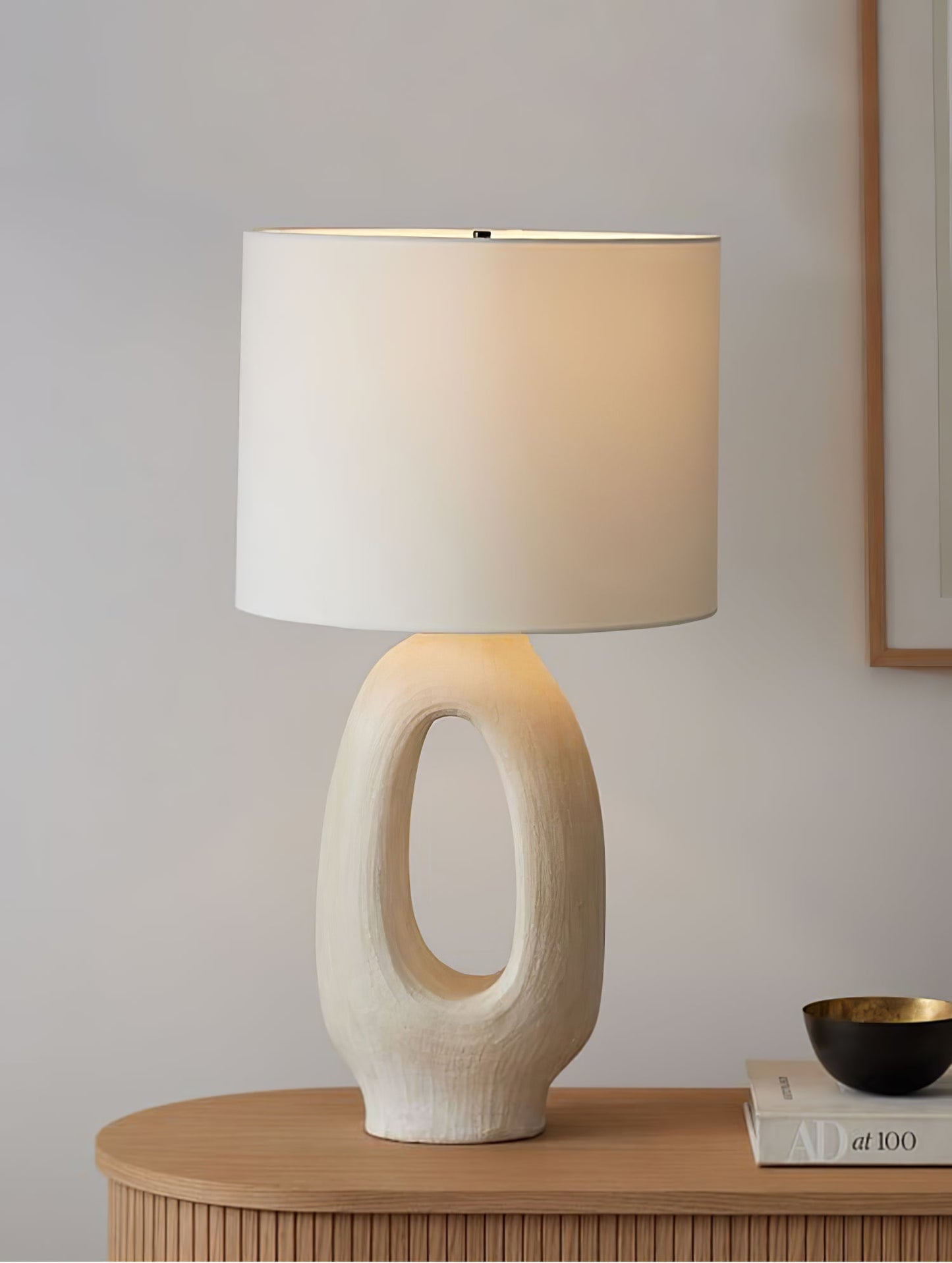 Based on the provided data:1. Core product: Table Lamp
2. Selling points: Sculptural design, ceramic base, available colors, fabric shade
3. New title: Sculptural Table Lamp | Ceramic Base | Beige, Black, White, Grey