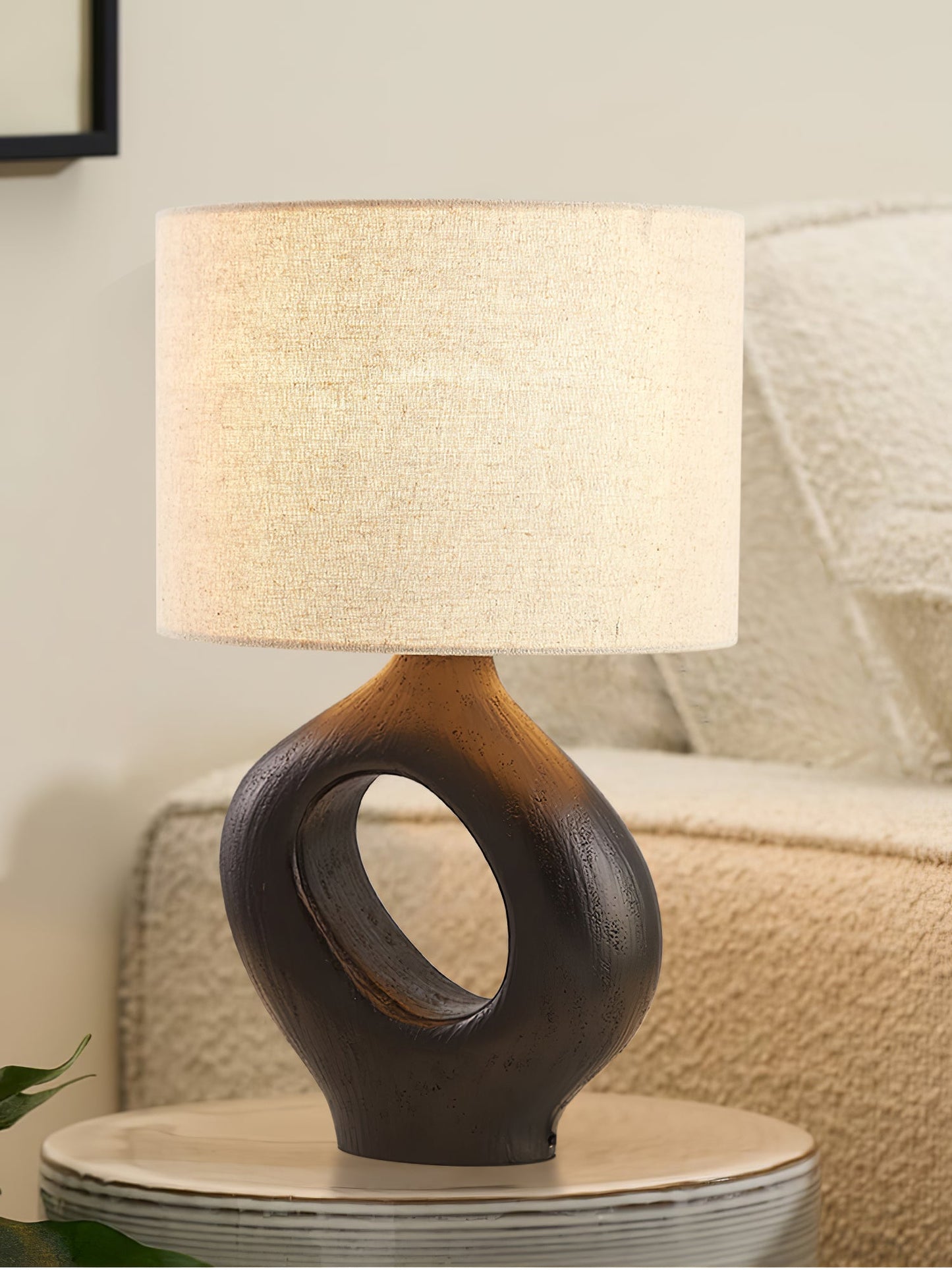 Based on the provided data:1. Core product: Table Lamp
2. Selling points: Sculptural design, ceramic base, available colors, fabric shade
3. New title: Sculptural Table Lamp | Ceramic Base | Beige, Black, White, Grey