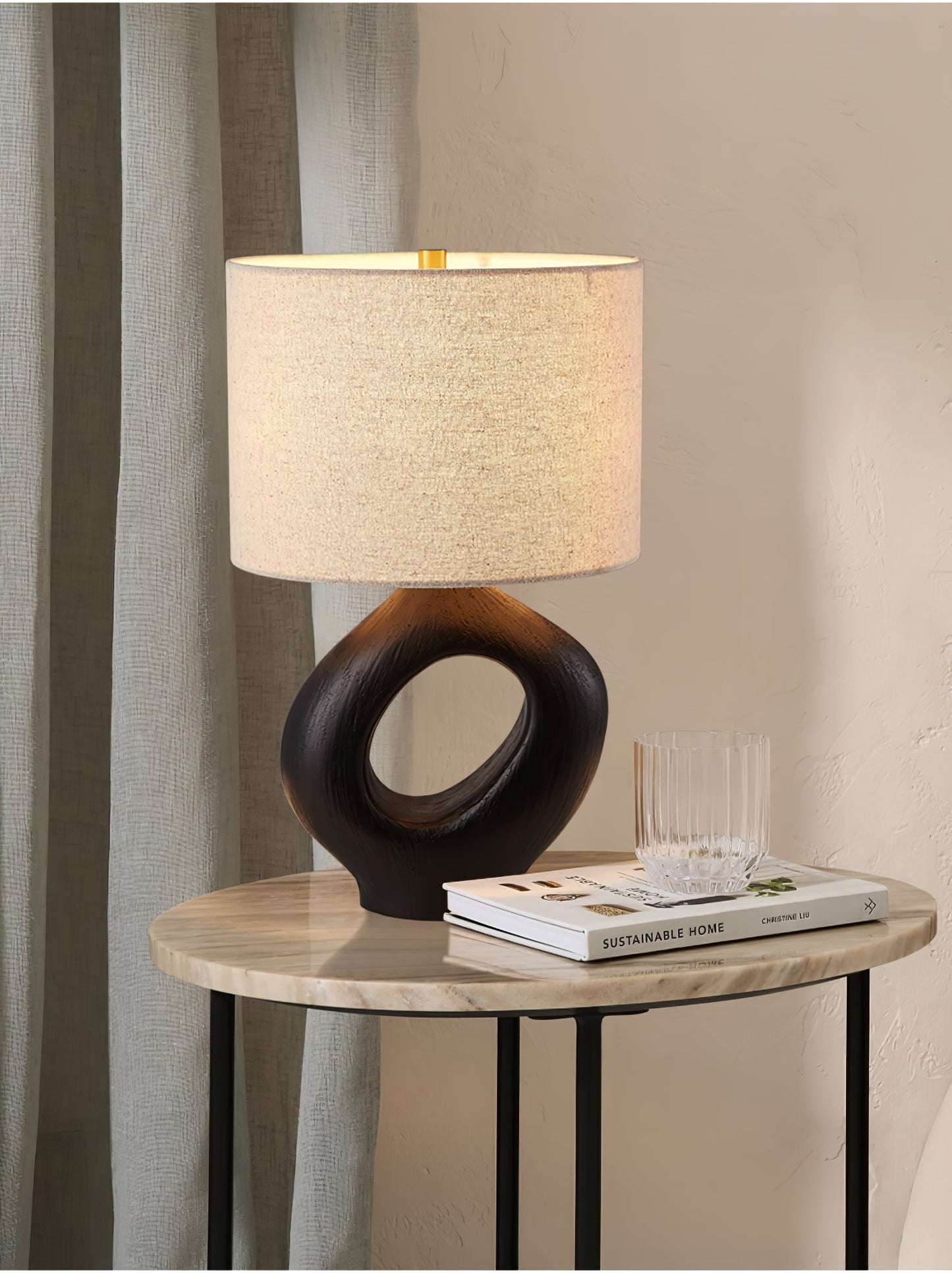 Based on the provided data:1. Core product: Table Lamp
2. Selling points: Sculptural design, ceramic base, available colors, fabric shade
3. New title: Sculptural Table Lamp | Ceramic Base | Beige, Black, White, Grey