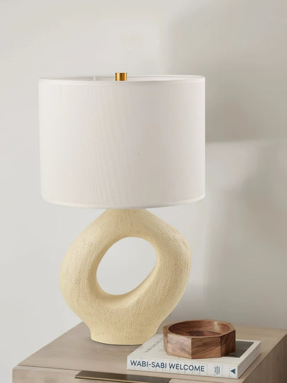Based on the provided data:1.  Core product: Table Lamp
2.  Selling points: Sculptural design, ceramic base, available colors, fabric shade
3.  New title: Sculptural Table Lamp | Ceramic Base | Beige, Black, White, Grey